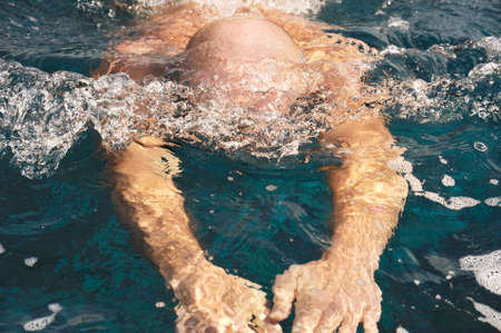 Detail of young man swimmingの写真素材