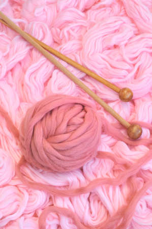 Sphere of pink wool with needlesの写真素材