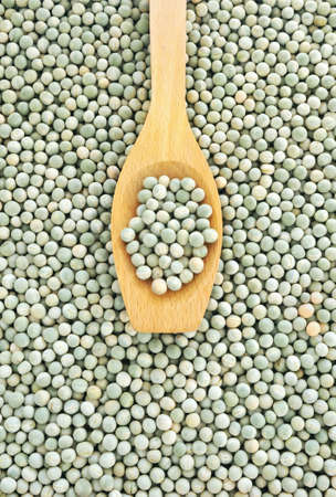 Wooden spoon and dried green split peasの写真素材