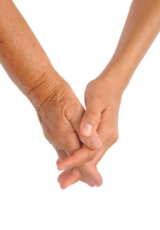 Hands of young and senior women - helping hand concept の写真素材