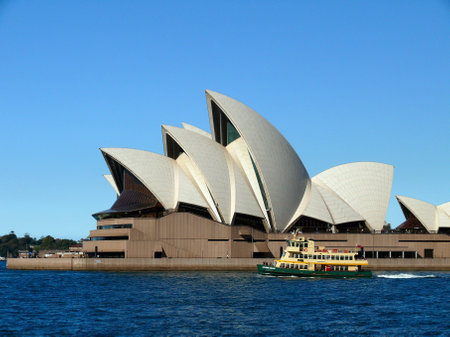 A ferry travels past the Sydney Opera House in Australiaのeditorial素材