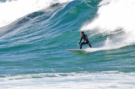 Surfers in action at Dee Why Beach in Sydney, Australia