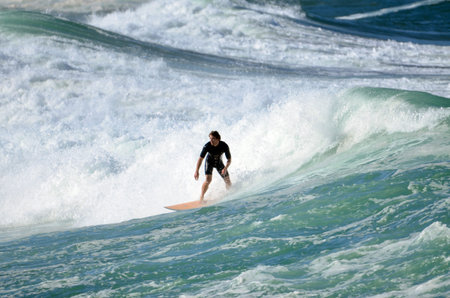 Surfers in action at Dee Why Beach in Sydney, Australia