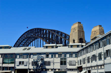 A view of the dock lands at Walsh Bay with the Sydney Harbor Bridge in the backgroundのeditorial素材