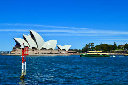 A ferry drifts by the Sydney Opera Houseのeditorial素材