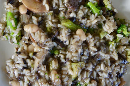 mushroom risotto with white beans and broccoliの写真素材
