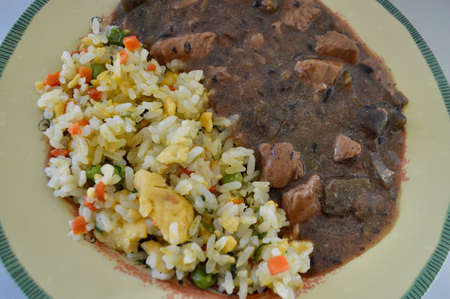 Chicken and black bean sauce with egg fried rice and vegetablesの写真素材