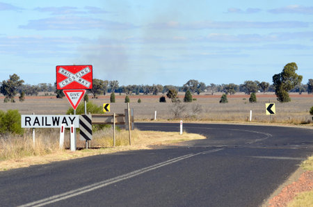 Signs in the Australian outback, with a highway in the background
