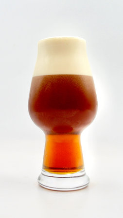 Glass of Irish style red ale isolated on a white background. Beer in a glassの写真素材