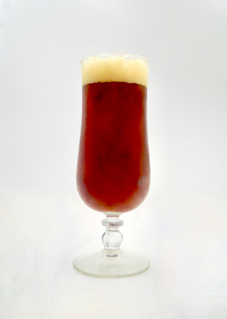 Frosty glass of red ale on a white background, isolatedの写真素材