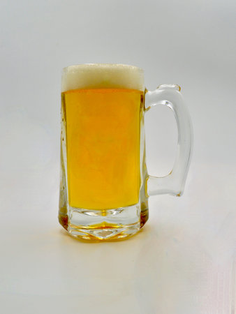 Mug of European lager isolated on a white background, close-up