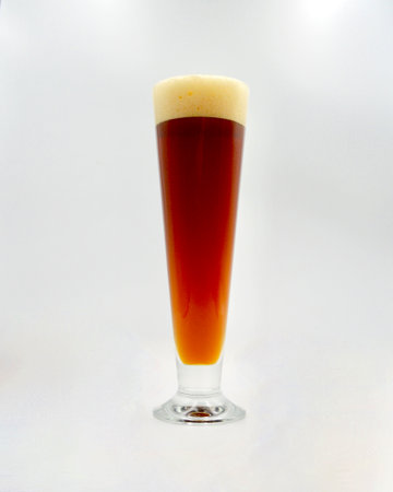 A glass of beer on a white background, close-up.の写真素材
