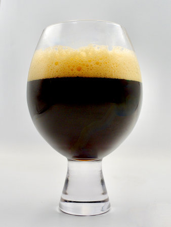 Dark beer in a glass on a white background. Isolated.の写真素材