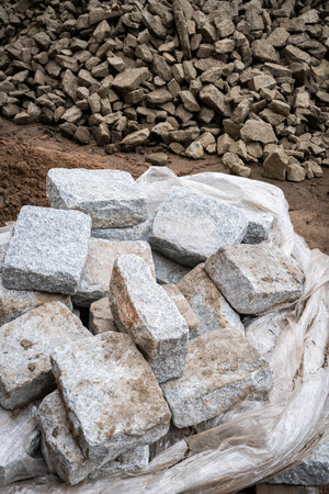 A pallet of Belgian blocks at a construction site with crushed rock in the backgroundの写真素材