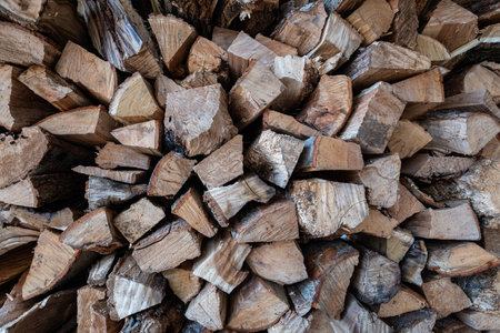 Closeup photograph of stacked split firewoodの写真素材