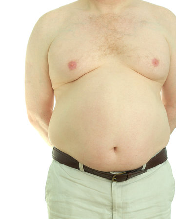 Front view of an overweight, middle-aged man naked from the waist up.の写真素材