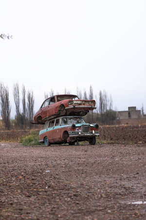 Abandoned cars on a dirt road in the countryside in autumn