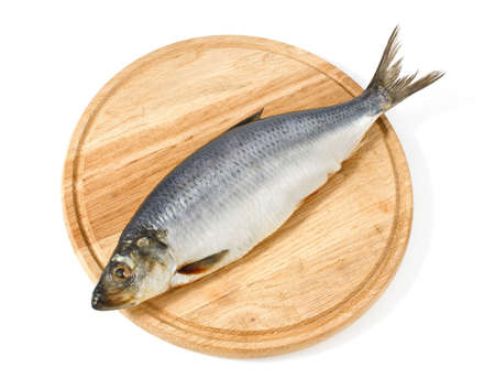 herring on wooden hardboard isolated white backgroundの写真素材