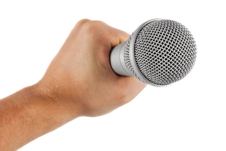 grey microphone in hand isolated on white backgroundの写真素材