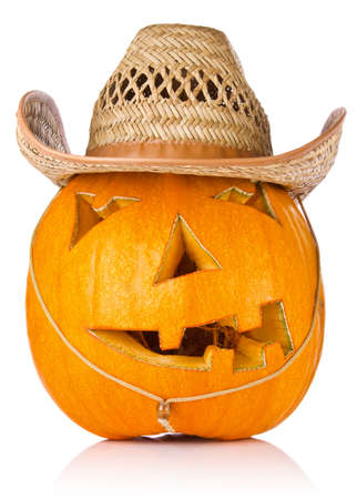 Halloween Pumpkin.Scary Jack O'Lantern in cowboy's cap isolated on white backgroundの写真素材