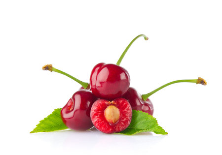 Ripe juicy cherry with green leaf. Isolated on white background