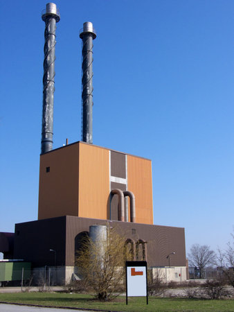 portrait of power plant with white sign infront for advertisement etc.