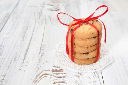 Festive wrapped chocolate homemade cookies on white wooden backgroundの写真素材
