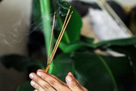 A close up image of a burning incense stick and smoke from incense burning. Beautiful smoke. Stick used for energy clearing and healing. White sage.の写真素材