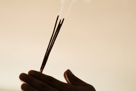 A close up image of a burning incense stick and smoke from incense burning. Beautiful smoke. Stick used for energy clearing and healing. White sage.の写真素材