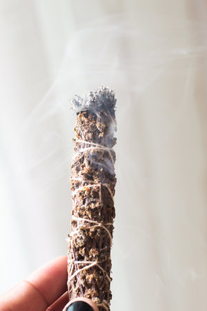 A close up image of a burning incense stick and smoke from incense burning. Beautiful smoke. Stick used for energy clearing and healing.の写真素材