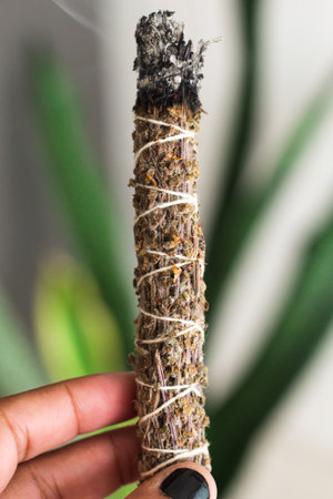 A close up image of a burning incense stick and smoke from incense burning. Beautiful smoke. Stick used for energy clearing and healing.の写真素材
