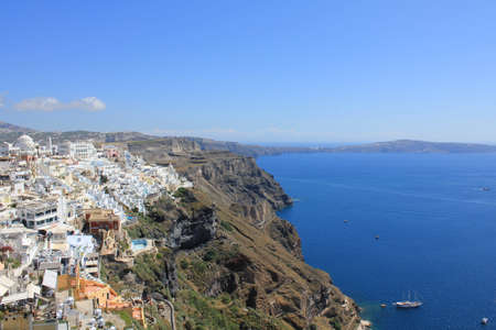View from the ocean, white houses, blue sky - Santorini / Greeceの写真素材