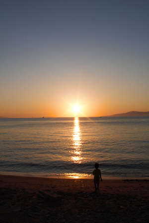 Sunset in beach, child playing - Greeceの写真素材