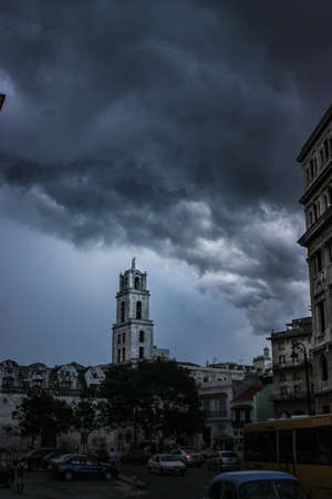 A hurricane is making its way on land in La Havana Cuba, creating a very oppressing scene with frightening lightening.の写真素材