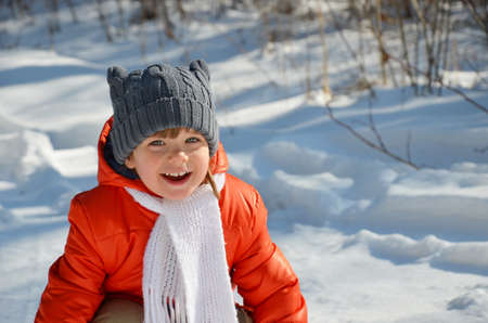 little girl walks in the woods winterの写真素材