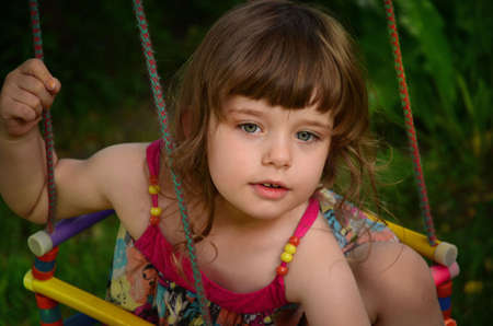 The happy little girl is playing in the garden.の写真素材