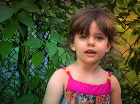 The happy little girl is playing in the garden.の写真素材