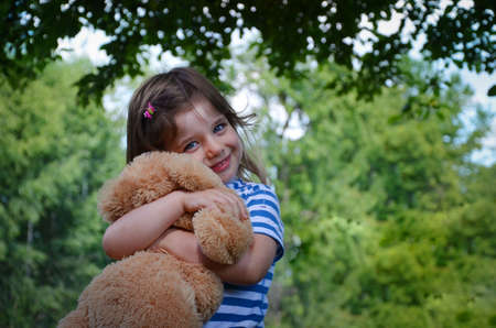 The happy little girl is playing in the garden.の写真素材