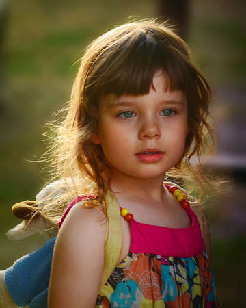 The happy little girl is playing in the gardenの写真素材