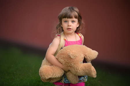 A little girl joking in the garden.の写真素材