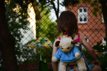 A little girl joking in the garden.の写真素材