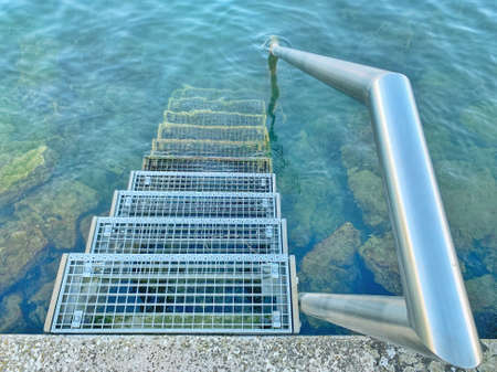 Metal stairs to the waterの写真素材