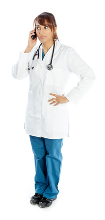 Attractive Indian doctor woman posing in a studio in front of a backgroundの写真素材