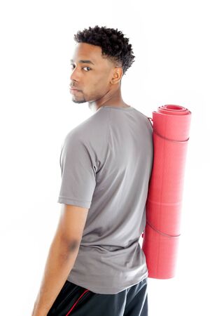 Attractive afro-american man posing in a  studio isolated on a backgroundの写真素材