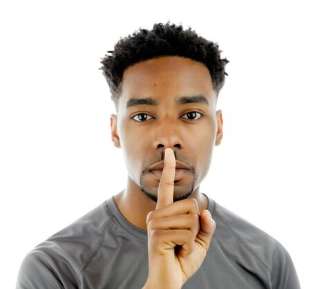 Attractive afro-american man posing in a  studio isolated on a backgroundの写真素材