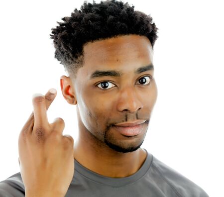 Attractive afro-american man posing in a  studio isolated on a backgroundの写真素材