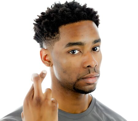 Attractive afro-american man posing in a  studio isolated on a backgroundの写真素材