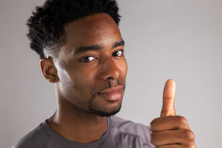 Attractive afro-american man posing in a  studio isolated on a backgroundの写真素材