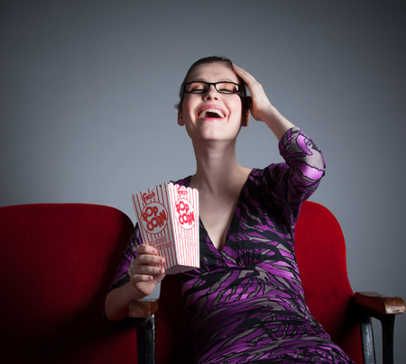 Attractive caucasian woman in the theatre in her 30 isolated on a grey backgroundの写真素材