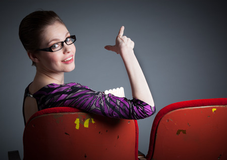 Attractive caucasian woman in the theatre in her 30 isolated on a grey backgroundの写真素材